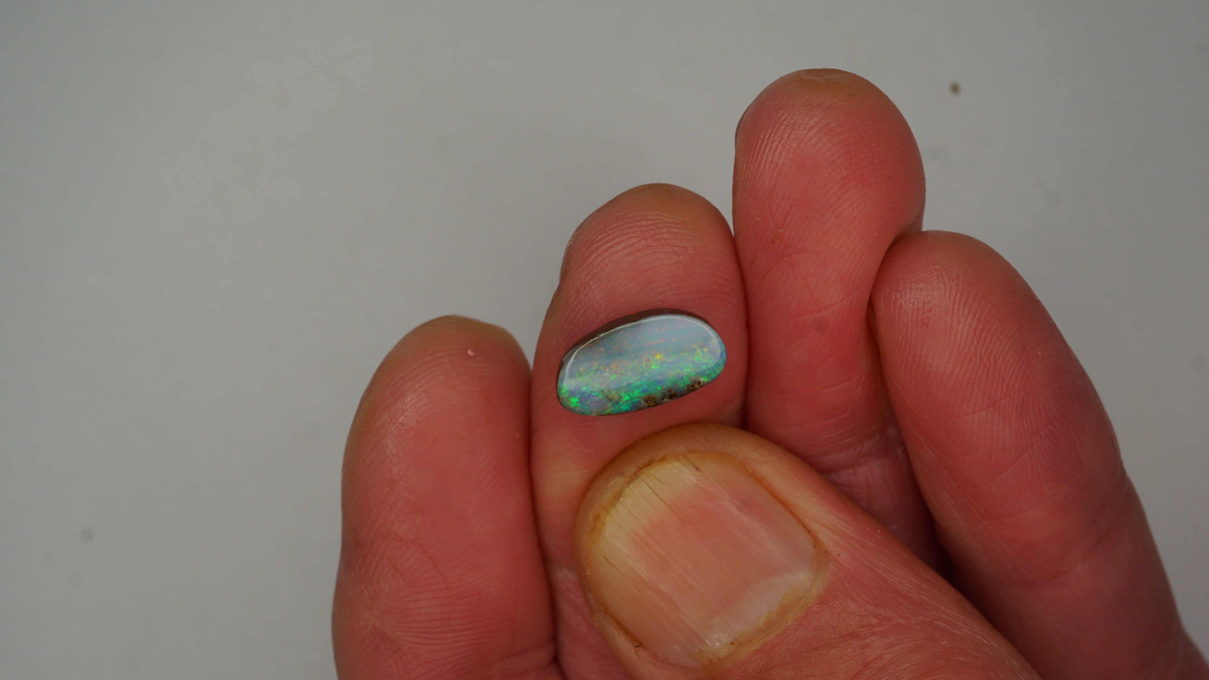 2.6ct Boulder Opal - Green, Blue & Crimson Play on Pale Purple Host Body Tone