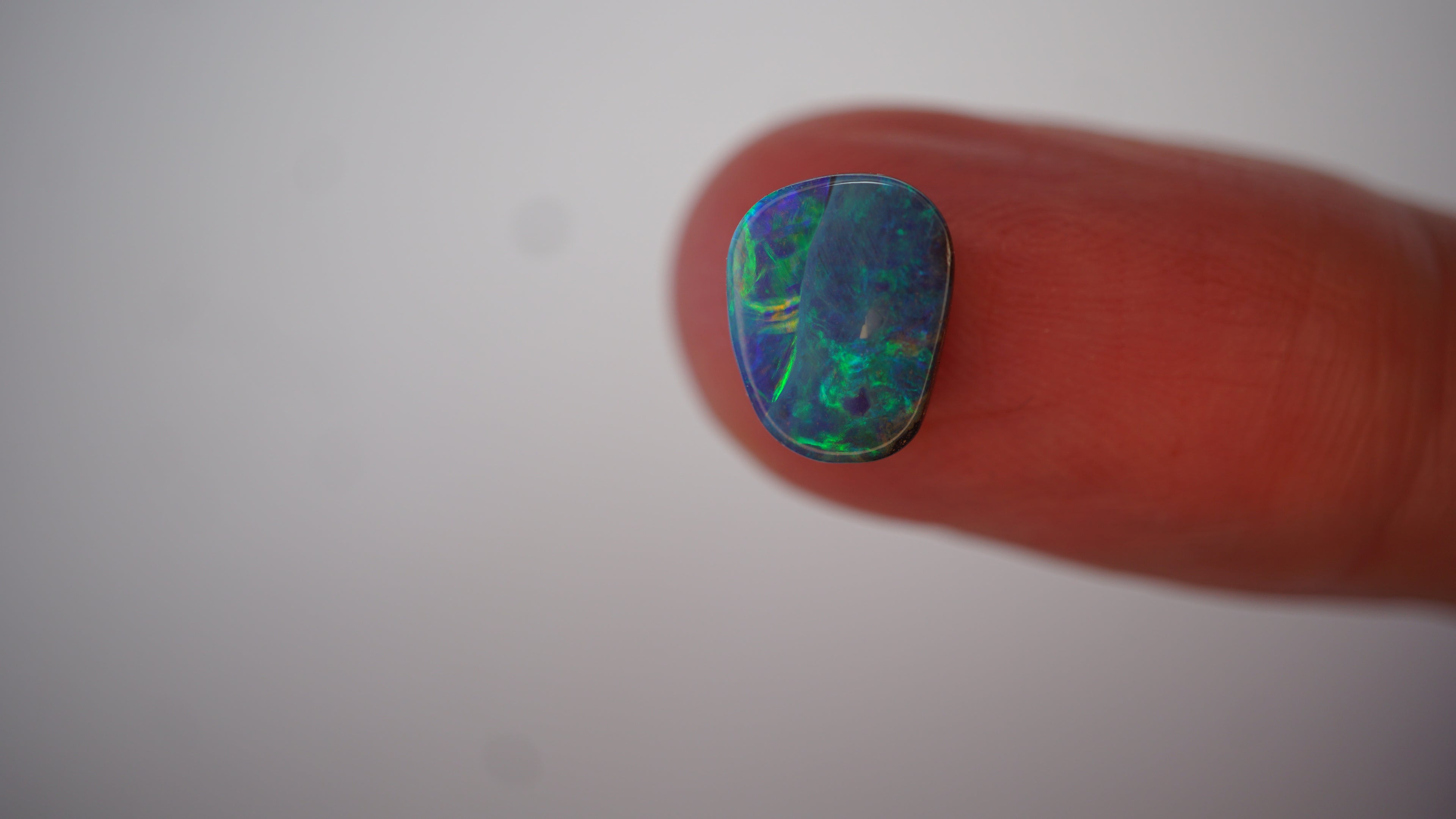 2.7ct Boulder Opal - Neon Green & Electric Blue Play on Blue Host Body Tone