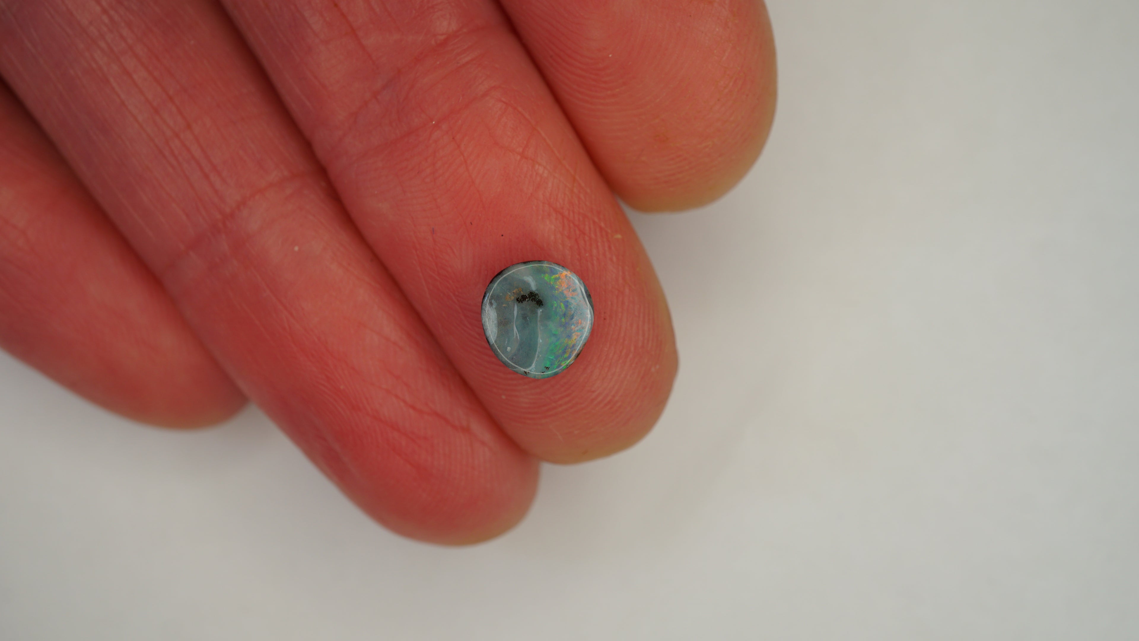 1.4ct Boulder Opal - Green & Orange Pinfire on White Base