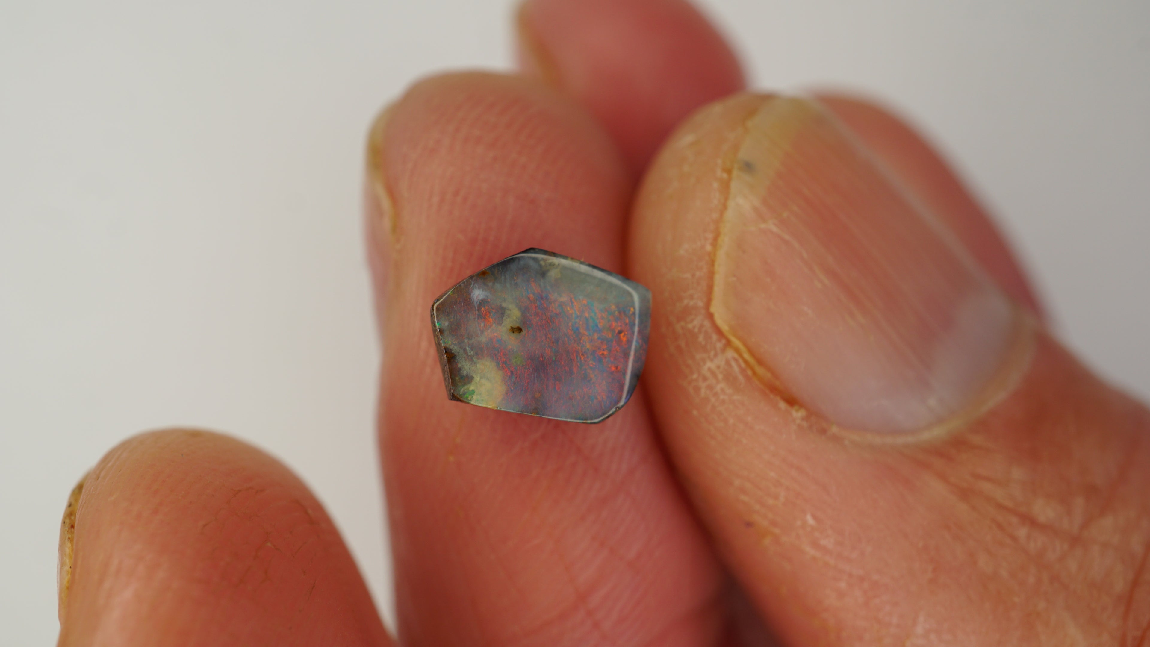 1.6ct Pentagonal Boulder Opal - Red Pinfire on Light Purple Base