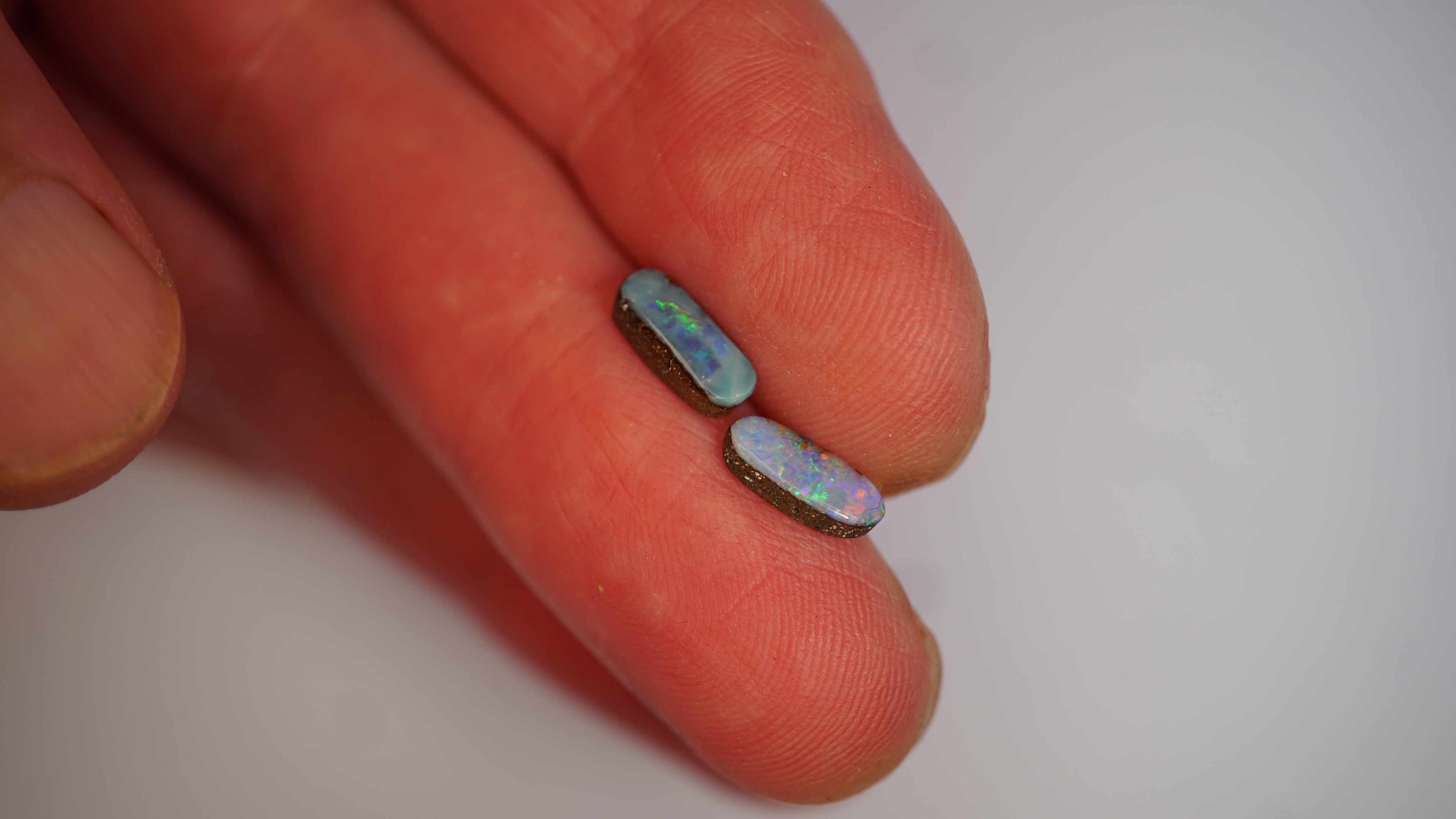 2.09ct Matched Boulder Opal Pair - Green & Violet Play on Sky Blue Host Body Tone