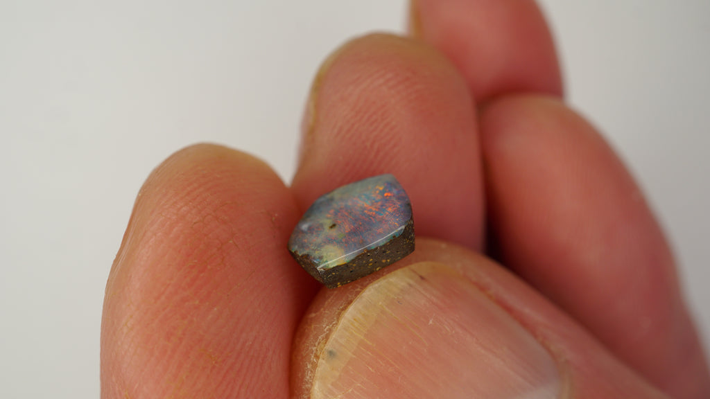 1.6ct Pentagonal Boulder Opal - Red Pinfire on Light Purple Base
