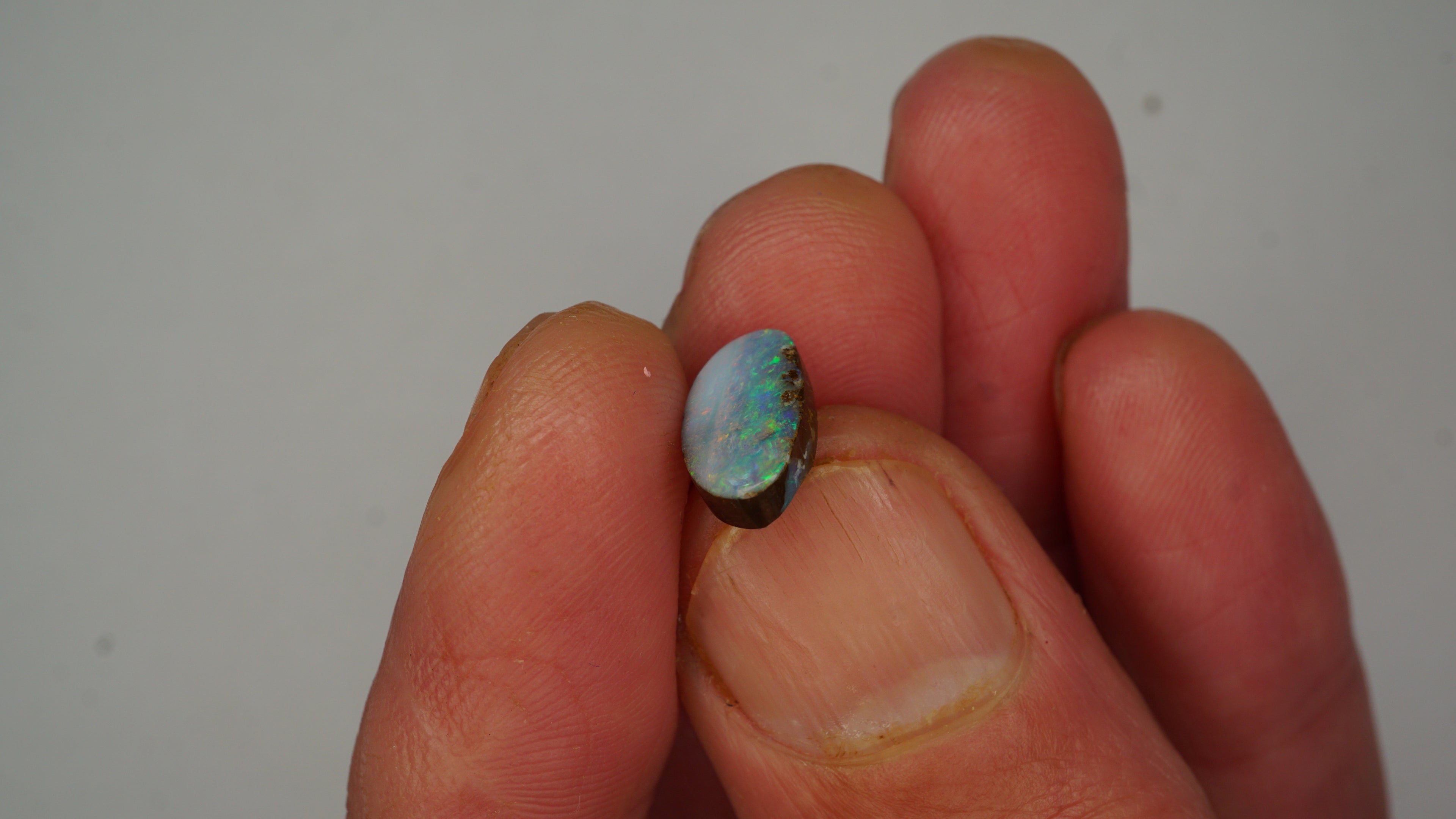 2.6ct Boulder Opal - Green, Blue & Crimson Play on Pale Purple Host Body Tone