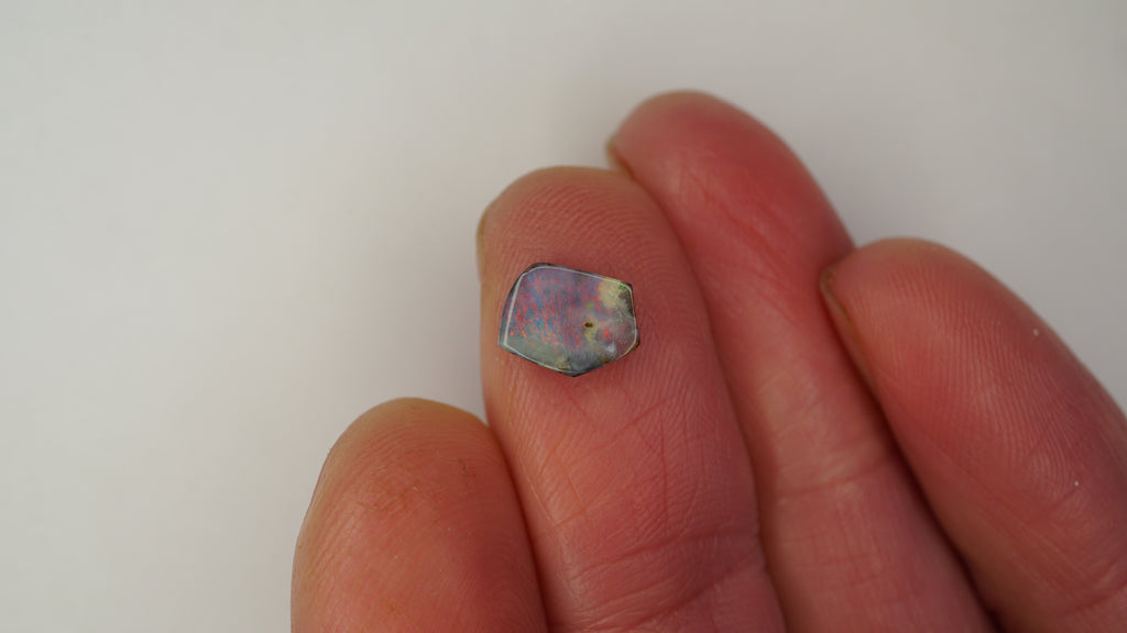 1.6ct Pentagonal Boulder Opal - Red Pinfire on Light Purple Base