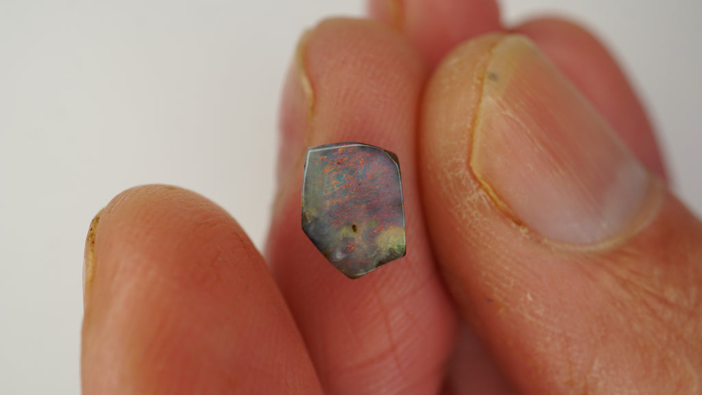 1.6ct Pentagonal Boulder Opal - Red Pinfire on Light Purple Base